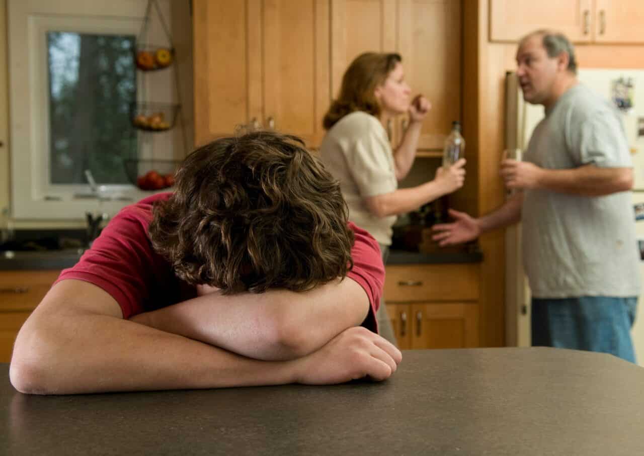 parents of child arguing in background over addiction