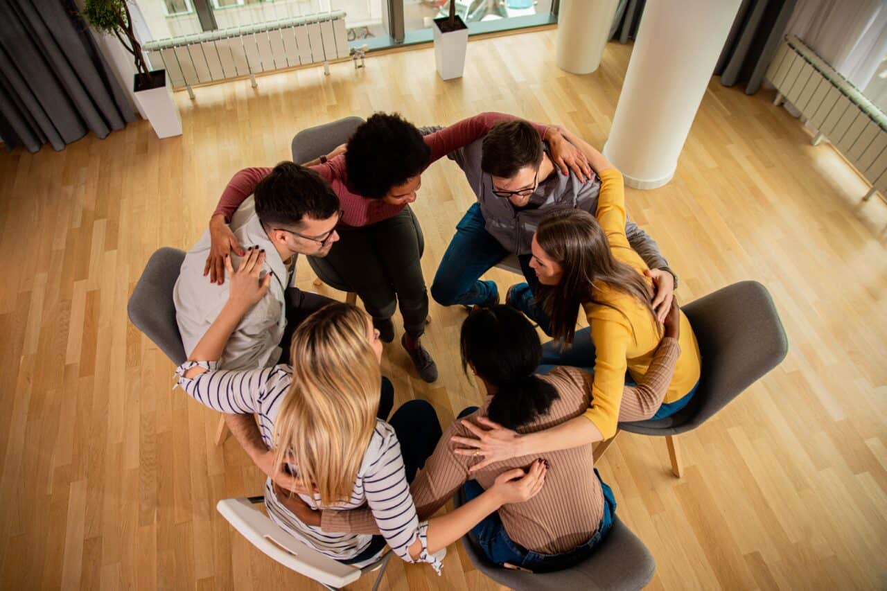 peer support group huddles together during detox in Austin