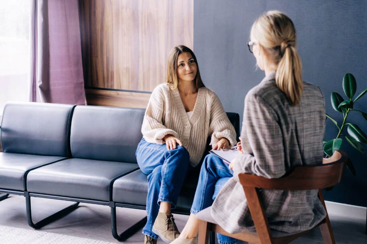 A woman talks to her therapist during drug detox in Austin.