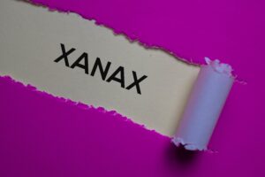 red sheet of paper with rip and the text xanax on it.