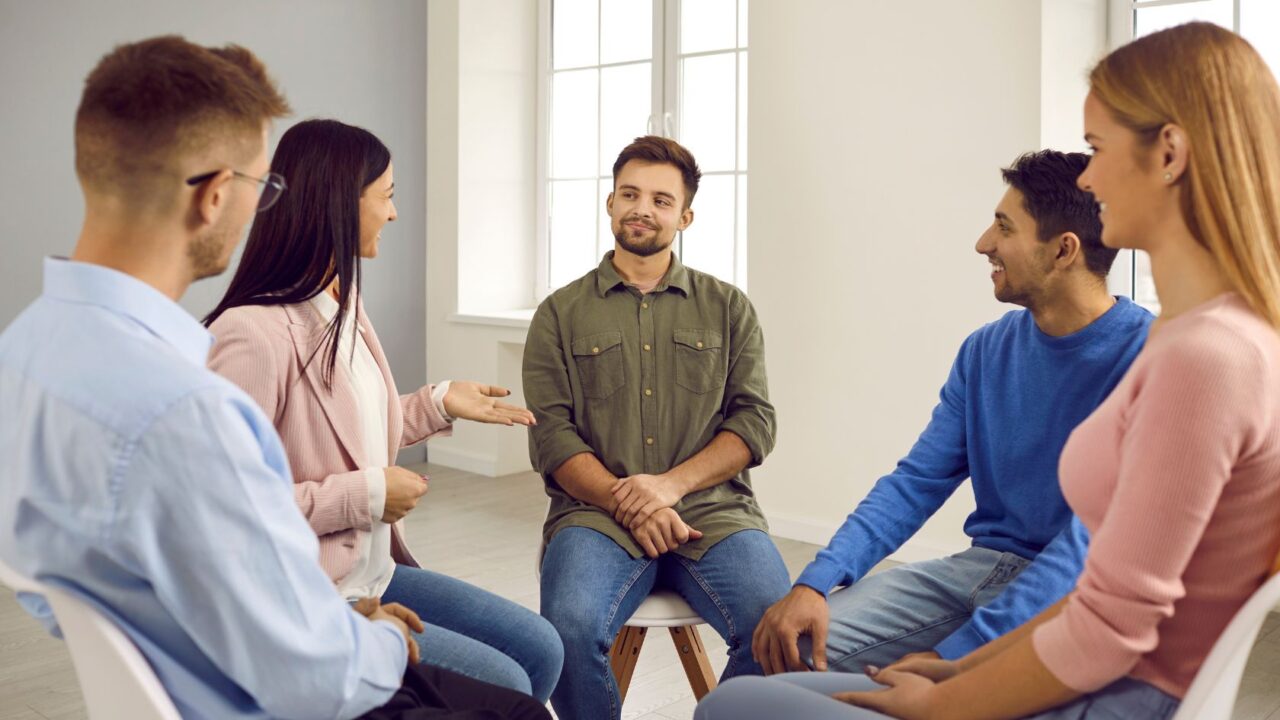 People enjoying group therapy as part of functional medicine for addiction recovery.