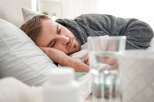 man laying down with detox symptoms