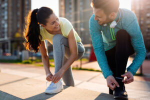 a-couple-gearing-up-to-run-in-nature