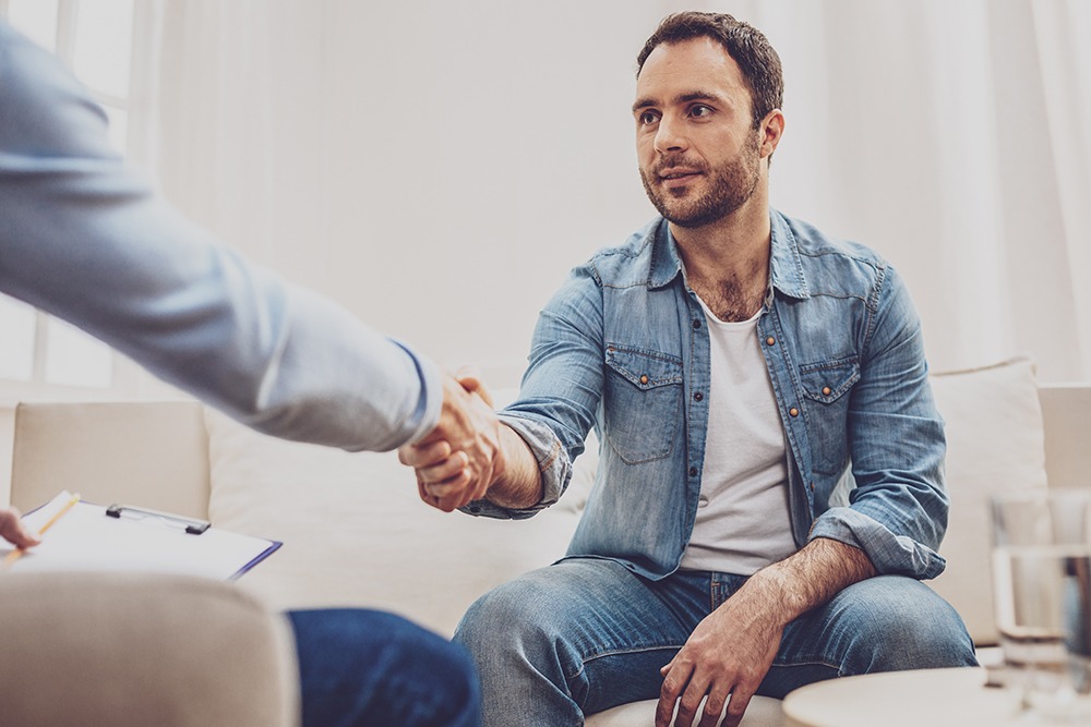 A Man Shaking Hands with His Therapist in Session