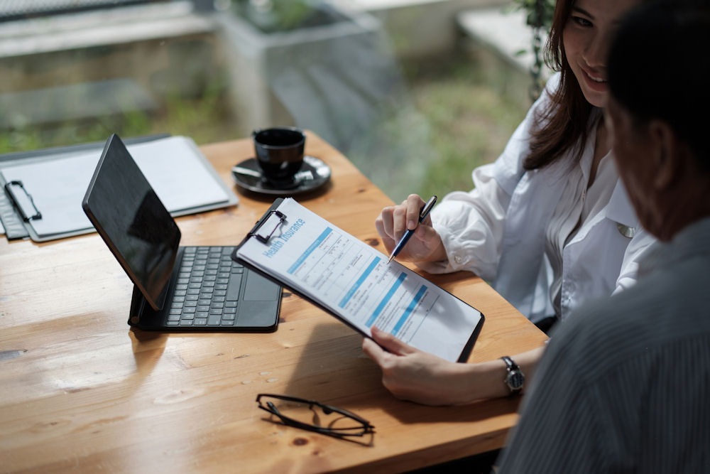 an-individual-filling-out-insurance-paperwork